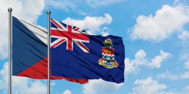 Çek Cumhuriyeti ve Cayman Adaları bayrağı birlikte beyaz bulutlu mavi gökyüzüne karşı rüzgarda sallayarak. Diplomasi kavramı, uluslararası ilişkiler.