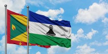 Grenada ve Lesotho bayrağı birlikte beyaz bulutlu mavi gökyüzüne karşı rüzgarda sallayarak. Diplomasi kavramı, uluslararası ilişkiler.