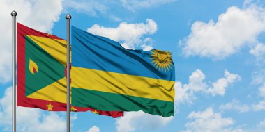 Grenada ve Ruanda bayrağı birlikte beyaz bulutlu mavi gökyüzüne karşı rüzgarda sallayarak. Diplomasi kavramı, uluslararası ilişkiler.