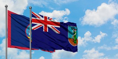 Guam ve Montserrat bayrağı birlikte beyaz bulutlu mavi gökyüzüne karşı rüzgarda sallayarak. Diplomasi kavramı, uluslararası ilişkiler.