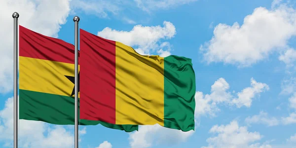 Ghana and Guinea flag waving in the wind against white cloudy blue sky together. Diplomacy concept, international relations. — Stock Photo, Image