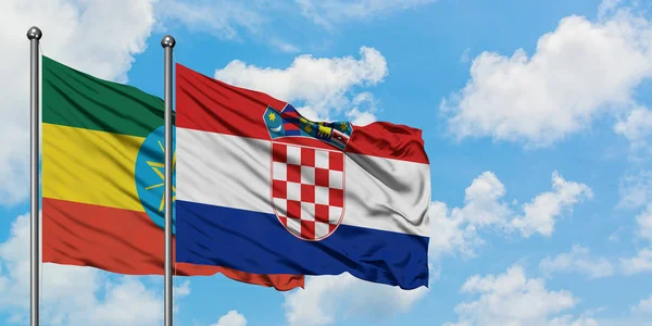 Etiopía y Croacia bandera ondeando en el viento contra blanco cielo azul nublado juntos. Concepto diplomático, relaciones internacionales . — Foto de Stock