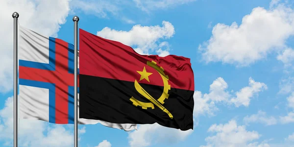 Ilhas Faroé e bandeira de Angola agitando no vento contra o céu azul nublado branco juntos. Conceito de diplomacia, relações internacionais . — Fotografia de Stock