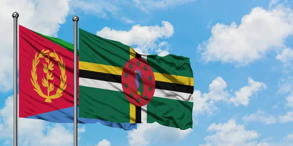 Eritrea and Dominica flag waving in the wind against white cloudy blue sky together. Diplomacy concept, international relations. — Stock Photo, Image