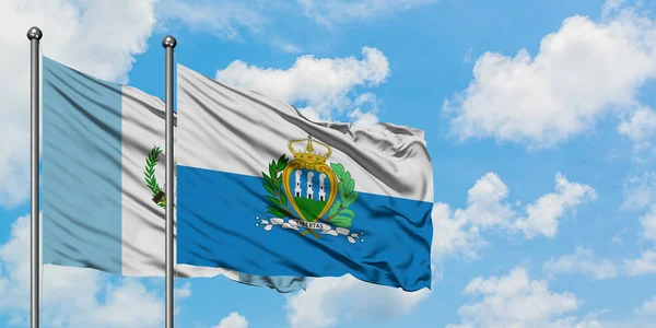 Guatemala ve San Marino bayrağı birlikte beyaz bulutlu mavi gökyüzüne karşı rüzgarda sallayarak. Diplomasi kavramı, uluslararası ilişkiler. — Stok fotoğraf