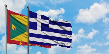 Grenada ve Yunanistan bayrağı birlikte beyaz bulutlu mavi gökyüzüne karşı rüzgarda sallayarak. Diplomasi kavramı, uluslararası ilişkiler.