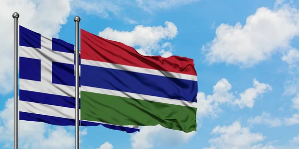 Grecia e Gambia sventolano nel vento contro il bianco cielo blu nuvoloso insieme. Concetto di diplomazia, relazioni internazionali . — Foto Stock