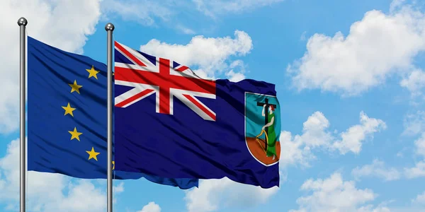 Avrupa Birliği ve Montserrat bayrağı birlikte beyaz bulutlu mavi gökyüzüne karşı rüzgarda sallayarak. Diplomasi kavramı, uluslararası ilişkiler. — Stok fotoğraf
