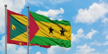 Grenada ve Sao Tome ve Principe bayrak birlikte beyaz bulutlu mavi gökyüzüne karşı rüzgarda sallayarak. Diplomasi kavramı, uluslararası ilişkiler.