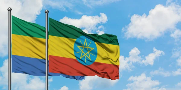 ガボンとエチオピアの旗が一緒に白い曇り青い空に対して風に振る。外交概念、国際関係. — ストック写真
