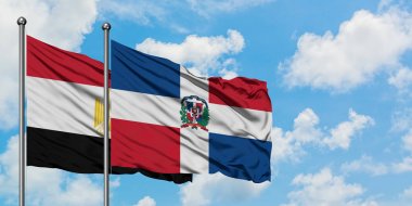 Mısır ve Dominik Cumhuriyeti bayrağı birlikte beyaz bulutlu mavi gökyüzüne karşı rüzgarsal sallayarak. Diplomasi kavramı, uluslararası ilişkiler.