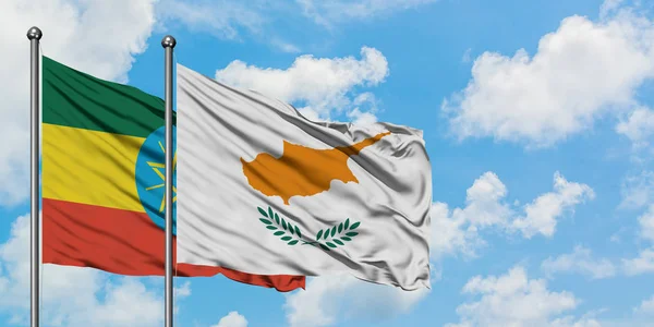 Ethiopia and Cyprus flag waving in the wind against white cloudy blue sky together. Diplomacy concept, international relations.