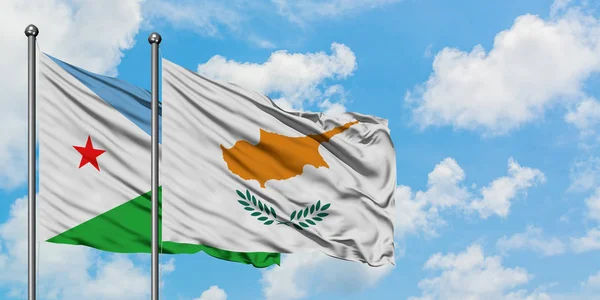 Djibouti and Cyprus flag waving in the wind against white cloudy blue sky together. Diplomacy concept, international relations.