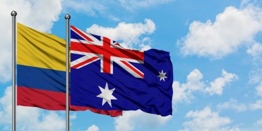 Kolombiya ve Heard Adası ve Mcdonald Adaları bayrağı birlikte beyaz bulutlu mavi gökyüzüne karşı rüzgarda sallayarak. Diplomasi kavramı, uluslararası ilişkiler.