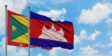 Grenada ve Kamboçya bayrağı birlikte beyaz bulutlu mavi gökyüzüne karşı rüzgarda sallayarak. Diplomasi kavramı, uluslararası ilişkiler.