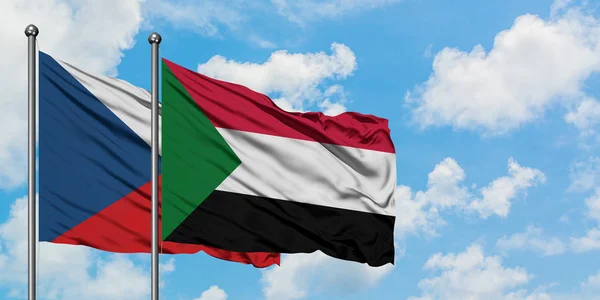 Bandera de República Checa y Sudán ondeando en el viento contra el cielo azul nublado blanco juntos. Concepto diplomático, relaciones internacionales . — Foto de Stock