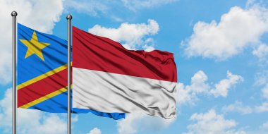 Kongo ve Endonezya bayrağı birlikte beyaz bulutlu mavi gökyüzüne karşı rüzgarsal sallayarak. Diplomasi kavramı, uluslararası ilişkiler.