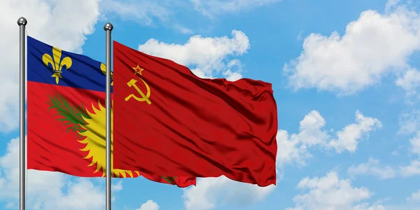 Guadeloupe and Soviet Union flag waving in the wind against white cloudy blue sky together. Diplomacy concept, international relations. — Stock Photo, Image