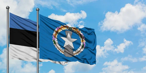 Estonia and Northern Mariana Islands flag waving in the wind against white cloudy blue sky together. Diplomacy concept, international relations. — Stock Photo, Image