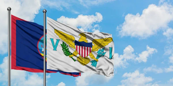 Guam a Americké Panenské ostrovy vlají ve větru proti bíle zatažené modré obloze. Diplomacie, mezinárodní vztahy. — Stock fotografie