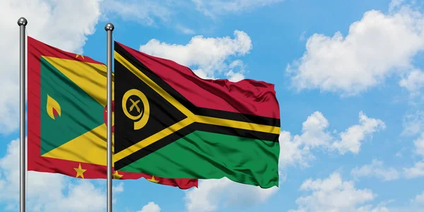 Grenada and Vanuatu flag waving in the wind against white cloudy blue sky together. Diplomacy concept, international relations. — Stock Photo, Image