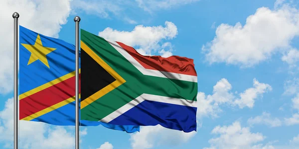 Congo and South Africa flag waving in the wind against white cloudy blue sky together. Diplomacy concept, international relations. — Stock Photo, Image