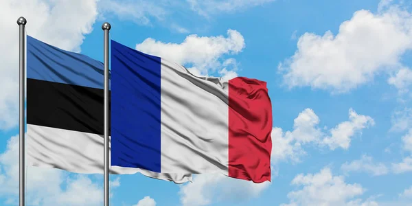 Estonia and France flag waving in the wind against white cloudy blue sky together. Diplomacy concept, international relations. — Stock Photo, Image