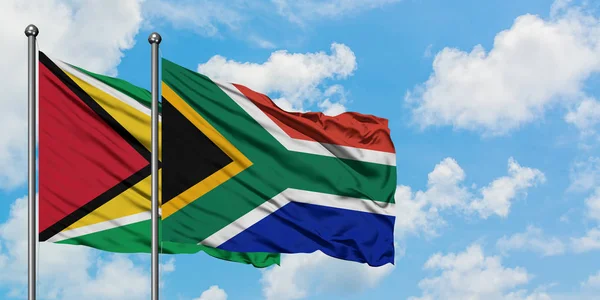 Guyana and South Africa flag waving in the wind against white cloudy blue sky together. Diplomacy concept, international relations. — Stock Photo, Image