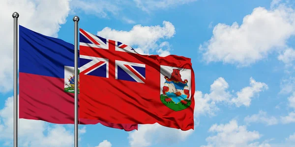Haïti en Bermuda vlag zwaaien in de wind tegen witte bewolkte blauwe hemel samen. Diplomatie concept, internationale betrekkingen. — Stockfoto