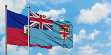 Haiti ve Fiji bayrağı birlikte beyaz bulutlu mavi gökyüzüne karşı rüzgarda sallayarak. Diplomasi kavramı, uluslararası ilişkiler.