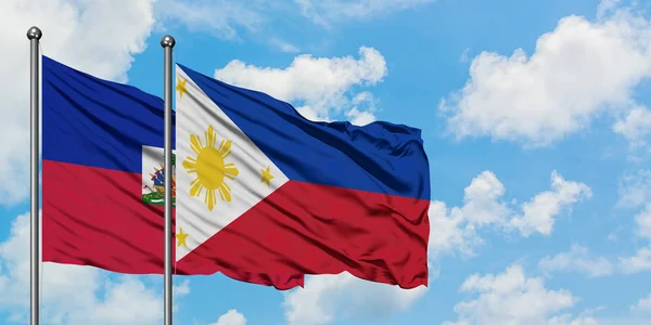 Haiti and Philippines flag waving in the wind against white cloudy blue sky together. Diplomacy concept, international relations. — Stock Photo, Image