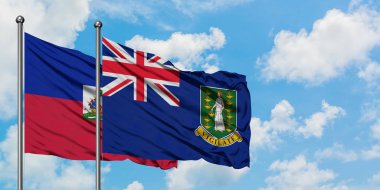 Haiti ve İngiliz Virgin Adaları bayrağı birlikte beyaz bulutlu mavi gökyüzüne karşı rüzgarda sallayarak. Diplomasi kavramı, uluslararası ilişkiler.