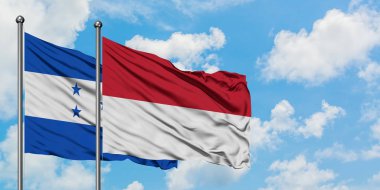 Honduras ve Endonezya bayrağı birlikte beyaz bulutlu mavi gökyüzüne karşı rüzgarsal sallayarak. Diplomasi kavramı, uluslararası ilişkiler.