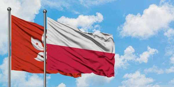 Bandera de Hong Kong y Polonia ondeando en el viento contra el cielo azul nublado blanco juntos. Concepto diplomático, relaciones internacionales . —  Fotos de Stock
