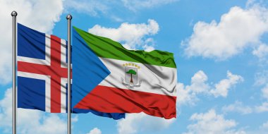 İzlanda ve Ekvator Ginesi bayrağı birlikte beyaz bulutlu mavi gökyüzüne karşı rüzgarda sallayarak. Diplomasi kavramı, uluslararası ilişkiler.