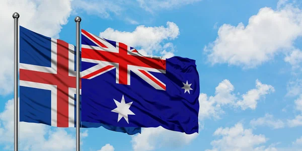 Island und hörte Insel und mcdonald Islands Flagge wehen im Wind vor weißem wolkenlosem blauen Himmel zusammen. Diplomatie-Konzept, internationale Beziehungen. — Stockfoto