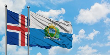 İzlanda ve San Marino bayrağı birlikte beyaz bulutlu mavi gökyüzüne karşı rüzgarda sallayarak. Diplomasi kavramı, uluslararası ilişkiler.