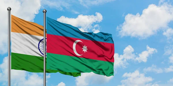 Bandera de la India y Azerbaiyán ondeando en el viento contra el cielo azul nublado blanco juntos. Concepto diplomático, relaciones internacionales . — Foto de Stock