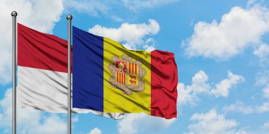 Irak ve Andorra bayrağı birlikte beyaz bulutlu mavi gökyüzüne karşı rüzgarda sallayarak. Diplomasi kavramı, uluslararası ilişkiler.