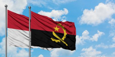 Irak ve Angola bayrağı birlikte beyaz bulutlu mavi gökyüzüne karşı rüzgarsal sallayarak. Diplomasi kavramı, uluslararası ilişkiler.