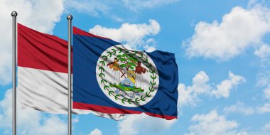 Irak ve Belize bayrağı havada havada sallayarak beyaz bulutlu mavi gökyüzüne karşı birlikte. Diplomasi kavramı, uluslararası ilişkiler.