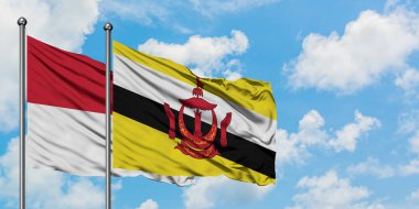 Irak ve Brunei bayrağı birlikte beyaz bulutlu mavi gökyüzüne karşı rüzgarda sallayarak. Diplomasi kavramı, uluslararası ilişkiler.