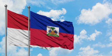 Irak ve Haiti bayrağı birlikte beyaz bulutlu mavi gökyüzüne karşı rüzgarda sallayarak. Diplomasi kavramı, uluslararası ilişkiler.