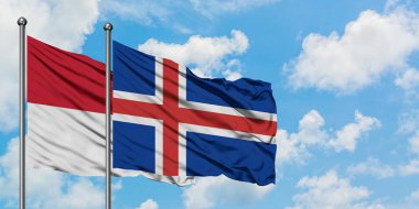 Irak ve İzlanda bayrağı birlikte beyaz bulutlu mavi gökyüzüne karşı rüzgarsal sallayarak. Diplomasi kavramı, uluslararası ilişkiler.