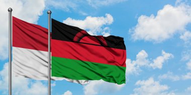 Irak ve Malavi bayrağı birlikte beyaz bulutlu mavi gökyüzüne karşı rüzgarda sallayarak. Diplomasi kavramı, uluslararası ilişkiler.