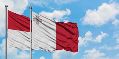 Irak ve Malta bayrağı birlikte beyaz bulutlu mavi gökyüzüne karşı rüzgarda sallayarak. Diplomasi kavramı, uluslararası ilişkiler.