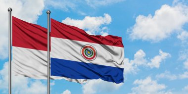 Irak ve Paraguay bayrağı birlikte beyaz bulutlu mavi gökyüzüne karşı rüzgarsal sallayarak. Diplomasi kavramı, uluslararası ilişkiler.