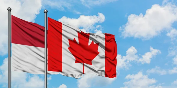 Bandera de Irak y Canadá ondeando en el viento contra el cielo azul nublado blanco juntos. Concepto diplomático, relaciones internacionales . — Foto de Stock