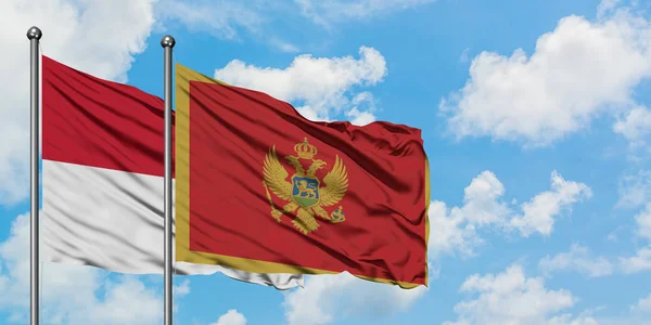 Irak och Montenegro flagga vinka i vinden mot vit grumlig blå himmel tillsammans. Diplomatisk koncept, internationella relationer. — Stockfoto