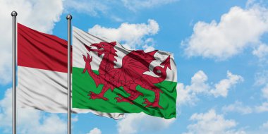 Irak ve Galler bayrağı birlikte beyaz bulutlu mavi gökyüzüne karşı rüzgarda sallayarak. Diplomasi kavramı, uluslararası ilişkiler.